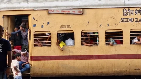India- 25-07-24: The train coach stands on the platform, with people at the door Stock Footage 283285757