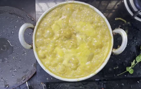 India dish getting boiled inside the aluminium pan Stock Footage 312321764
