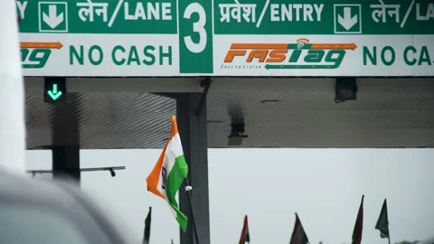 India flag waving in the wind in front of a toll booth with FASTag and no cash Stock Footage 163462148