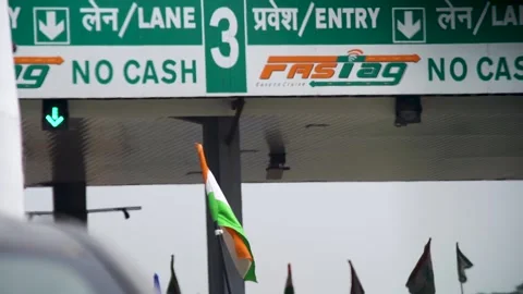 India flag waving in the wind in front of a toll booth with FASTag and no cash Stock Footage 163462534