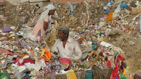India garbage dump, people search items to recycle, urban scene, poverty Stock Footage