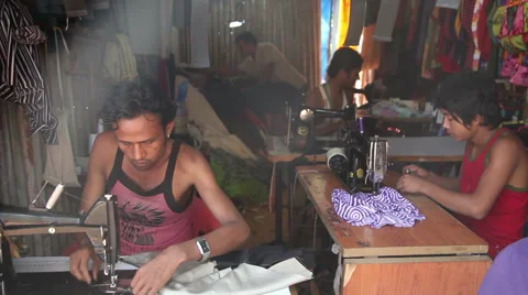 INDIA, GOA - 2012: The Indian men sew clothes for sale Stock Footage 45591541