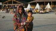 India, Goa - 2012: Old Indian Woman In Traditional Dress Holds A Child Stock Footage
