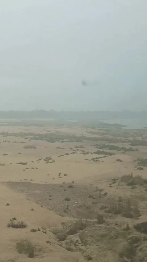 India - January 21, 2024: Train Window View Crossing Misty Sandy Riverbed Stock Footage 336624223