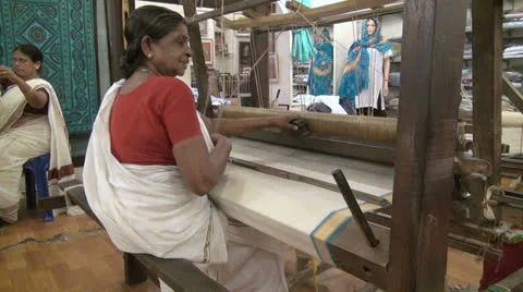 India Kerala woman seated operates handloom  Stock Footage