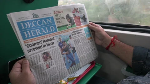 India, a man reading a newspaper in the express train Stock Footage 48804008
