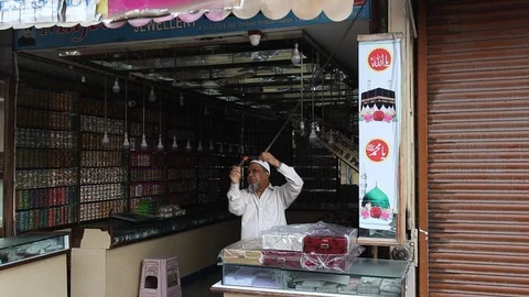 India man works on manual-retractable-awning Stock Footage 104993554