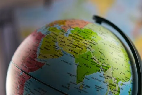 India map on a globe with earth map in the background. Stock Photos