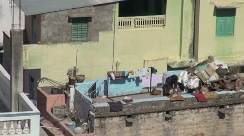 India Rajasthan Deogarh folding clothes on rooftop wall  Stock Footage 24454576