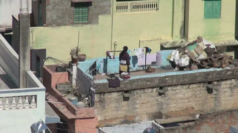 India Rajasthan Deogarh folding clothes on rooftop zoom  Stock Footage 24455382