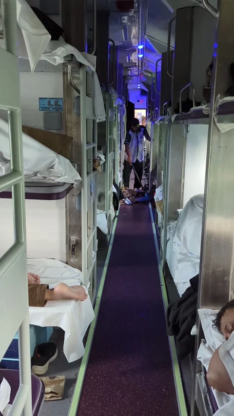 India - Sept 24, 2024: Inside 3rd AC Coach with Cleaning Staff and Passengers Stock Footage 293200542