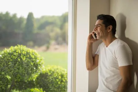 India, Smiling man talking on mobile phone Stock Photos