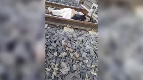 India: Student rescued after attempted suicide on train tracks in northern I... Stock Footage 284110880