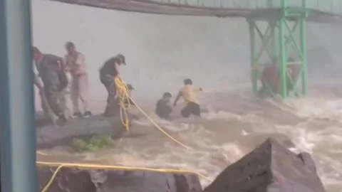 India: Sudden flood at waterfall traps visitors in northern India; swift res... Stock Footage 280449355