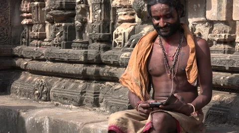 India technology contrast, religious guru uses modern smartphone in temple Stock Footage