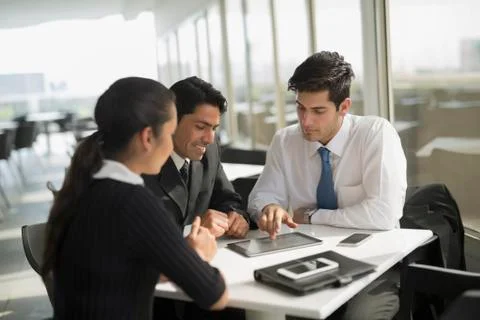 India, Three colleagues working in cafeteria Stock Photos
