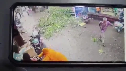 India: Tree branch crashes onto power lines in main market, broken wires ... Stock Footage 344152653
