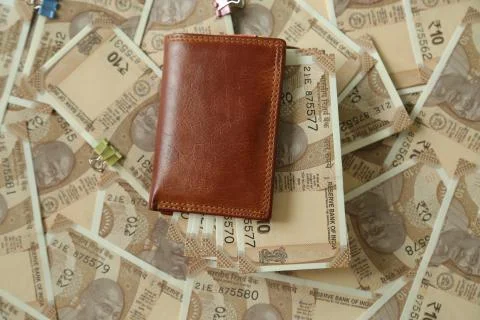 Indian 10 rupee currency notes in a wallet and on the table Stock Photos