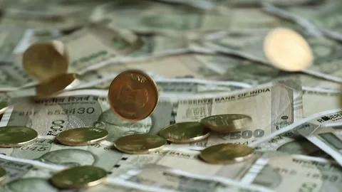 Indian 5 rupees coins falling down on 500 indian banknotes. Stock Footage 277159448