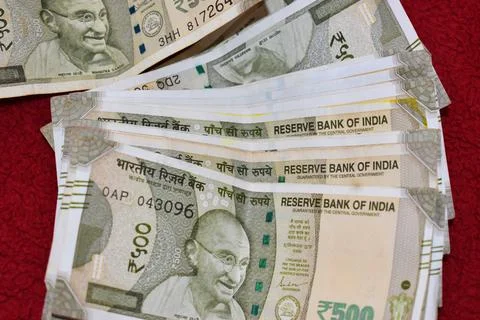 Indian 500 Rupees notes on red background Stock Photos