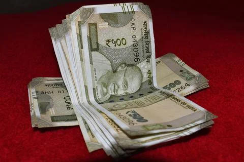 Indian 500 Rupees notes on red background Stock Photos