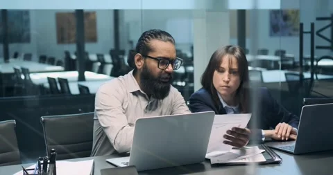 Indian and Caucasian Managers Working in Modern Office Stock Footage 250028340