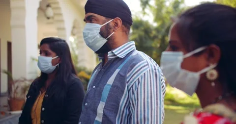 Indian and nurses in full body ppe suit share talk discuss teamwork together Stock Footage 146330656