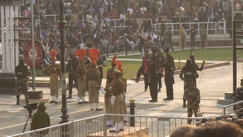 Indian and Pakistani Border Guards Facing off at Daily Flag Lowering Ceremony Stock Footage 129333942