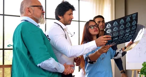 Indian Asian group of professional doctors surgeons collaborating and discussing Stock Footage 342574397