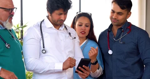 Indian Asian group of professional doctors surgeons collaborating and discussing Stock-Footage 342574411