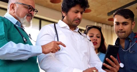 Indian Asian group of professional doctors surgeons collaborating and discussing Stock Footage 342574420