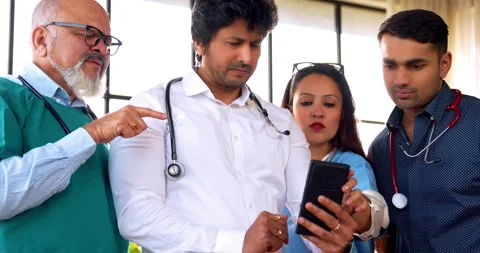 Indian Asian group of professional doctors surgeons collaborating and discussing Stock Footage 342574431