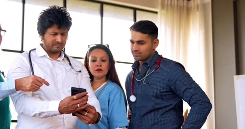 Indian Asian group of professional doctors surgeons collaborating and discussing Stock Footage 342574457