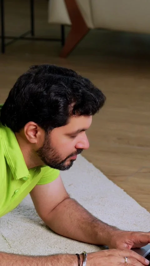 Indian asian man using laptop son playing mobile game together on carpet Stock Footage 342758125