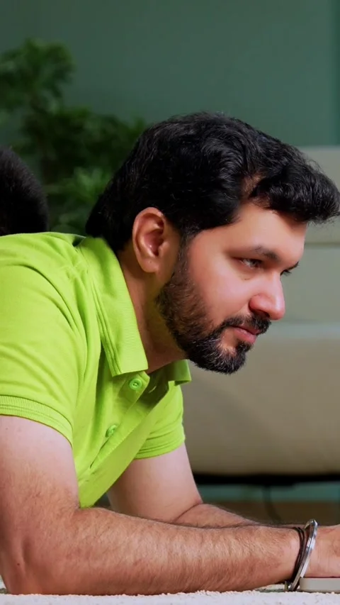 Indian asian man using laptop son playing mobile game together on carpet Stock Footage 342758131