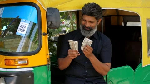 An Indian auto driver counting his earnings - daily earning concept, lifestyl... Stock Footage 260802613