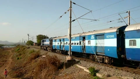 Indian Blue Express Train Speed Crossing Vaitarna Railway station Mumbai India Stock Footage 153696208