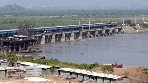 Indian Blue Passenger Express Train Crossing Railway River bridge Mumbai India Video stock 129428581