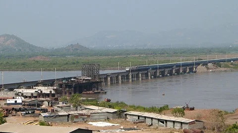 Indian Blue Passenger Express Train Crossing Railway River bridge Mumbai India Video stock 129443214