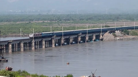 Indian Blue Passenger Express Train Crossing Railway River bridge Mumbai India Stock Footage 136112443