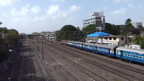 Indian Blue Passenger Train moving Crossing near railway station Mumbai India Video stock 130590580