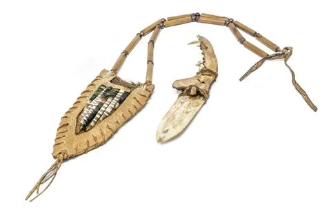 Indian bone knife with a fox pine handle in a rawhide quiver decorated with Stock Photos