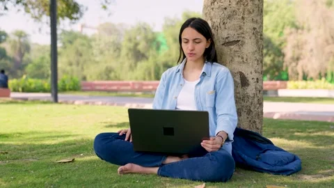 Indian boss doing a work call from a park 스톡 동영상 230420610