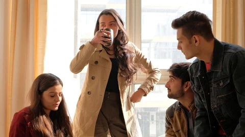 Indian boss instructs her team while one colleagues is sipping coffee in a room  Stock Footage 101159339