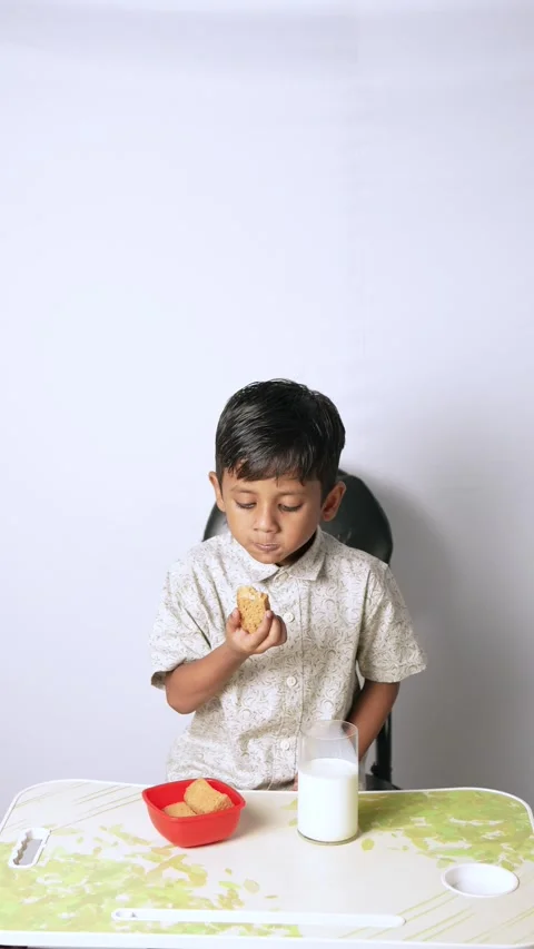 Indian Boy Eating Biscuits with Milk Stock Footage 341323101