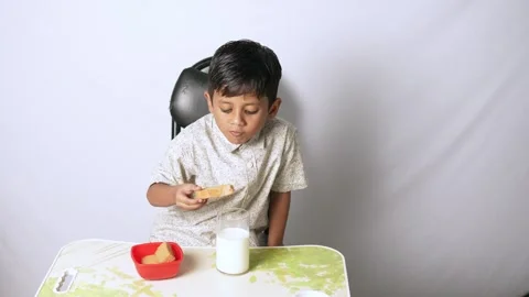 Indian Boy Eating Bread and Milk Stock Footage 341248791