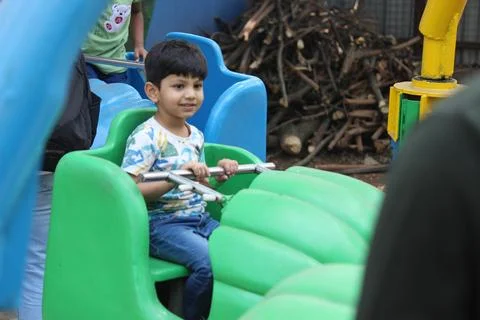 Indian boy is enjoying aero plane ride in a amusement park Stock Photos