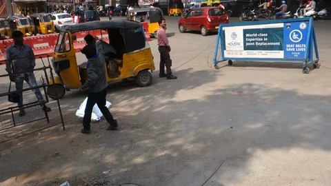 Indian Boy flies kite on a busy street Stock Footage 100814571