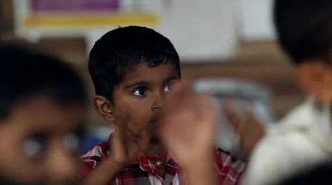 Indian boy goofing around in class in rural village school in Kerela, India Stock Footage 33841346