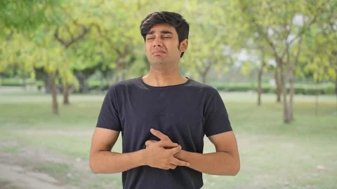 Indian boy having acidity and gastric problem Stock Footage 243088891